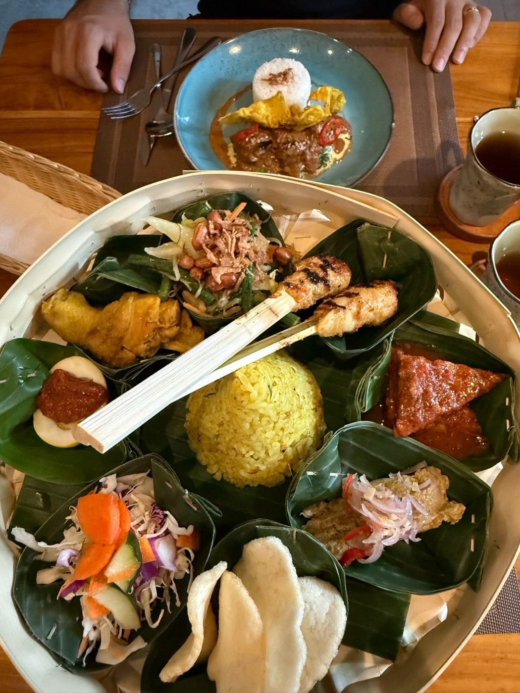 Lunch in Ubud. Yellow rice, satay and Balinese side dishes